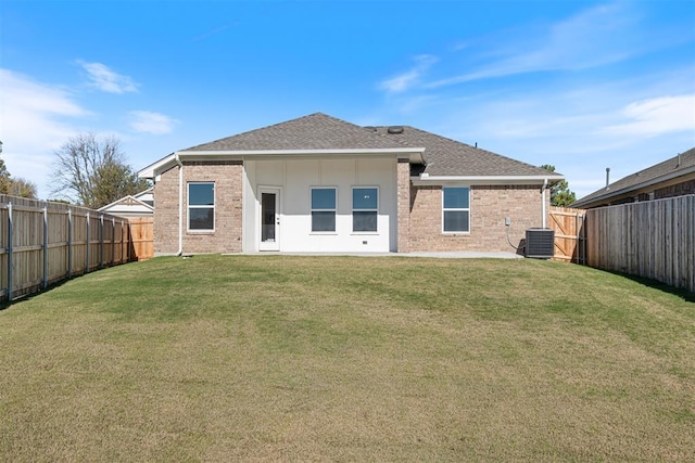 back of house with a lawn and central air condition unit