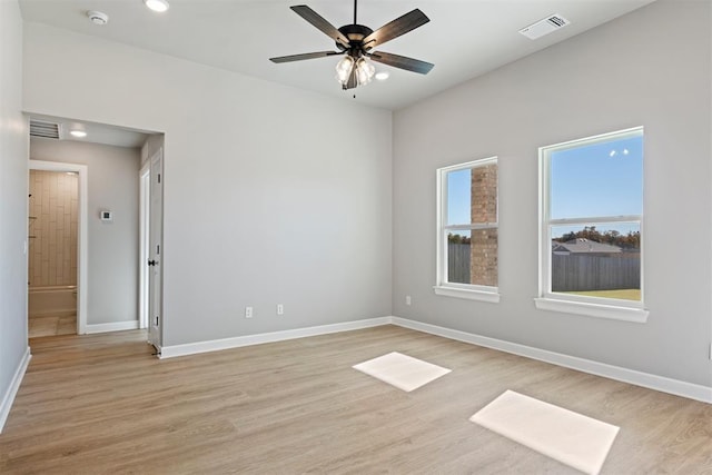 empty room featuring ceiling fan and light hardwood / wood-style floors