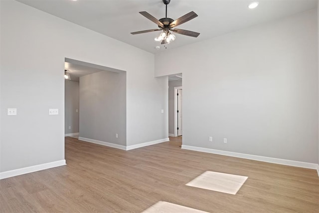 empty room with ceiling fan and light hardwood / wood-style flooring