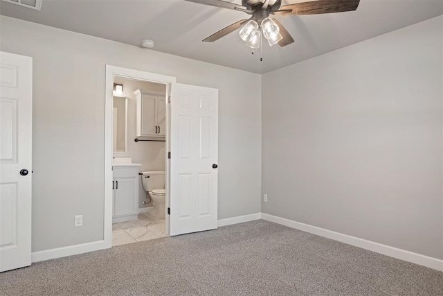 unfurnished bedroom with connected bathroom, light colored carpet, and ceiling fan