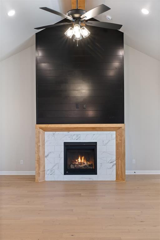 room details featuring a fireplace, hardwood / wood-style floors, and ceiling fan