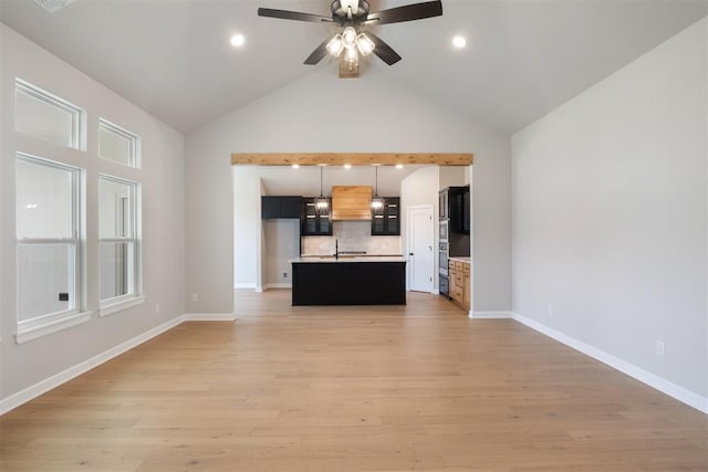 unfurnished living room with ceiling fan, light hardwood / wood-style floors, and high vaulted ceiling