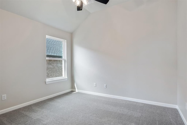 carpeted empty room featuring vaulted ceiling and ceiling fan