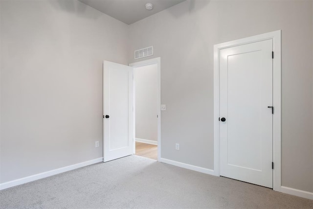 unfurnished room with light colored carpet