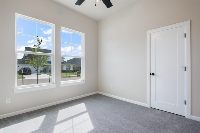 carpeted empty room with ceiling fan