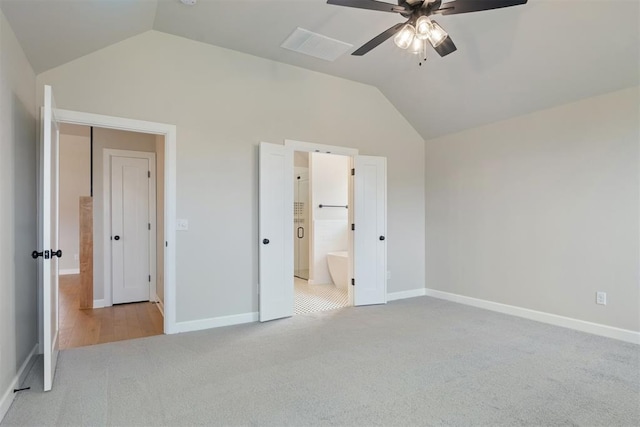 unfurnished bedroom with light carpet, ensuite bath, ceiling fan, and lofted ceiling