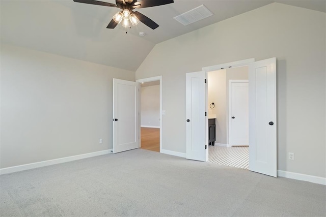 unfurnished bedroom with ceiling fan, high vaulted ceiling, and light colored carpet