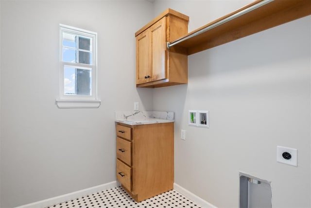 washroom featuring hookup for an electric dryer, hookup for a washing machine, and cabinets