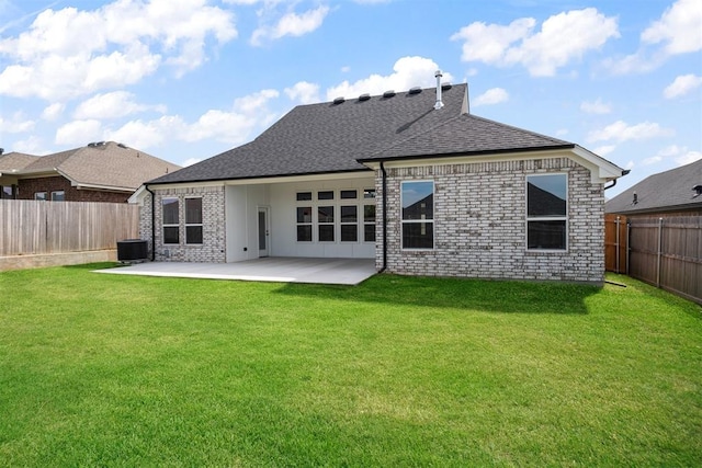 back of property with a lawn, a patio area, and central air condition unit