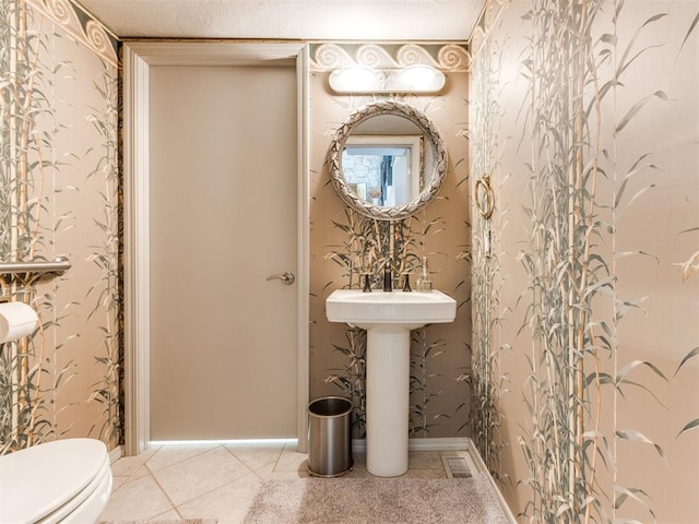 bathroom with tile patterned flooring and toilet