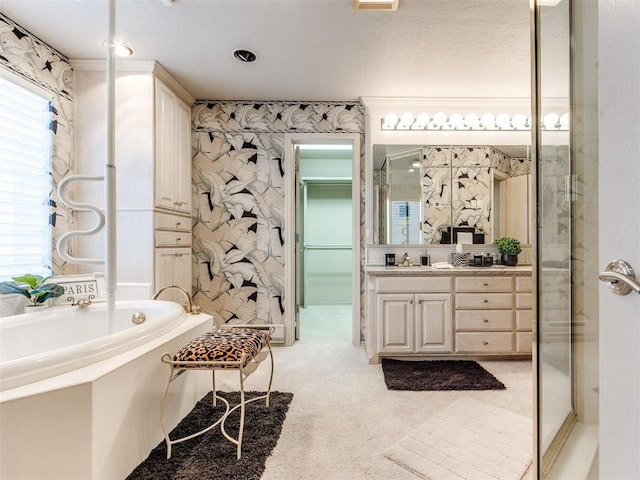 bathroom featuring vanity and shower with separate bathtub