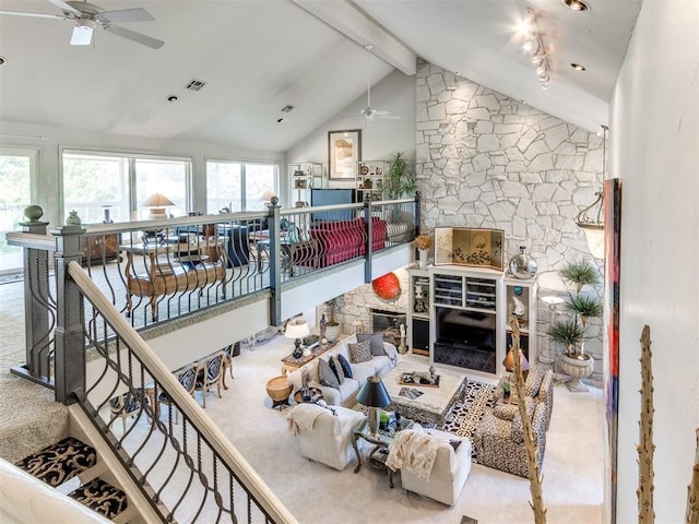 carpeted living room with vaulted ceiling with beams and ceiling fan