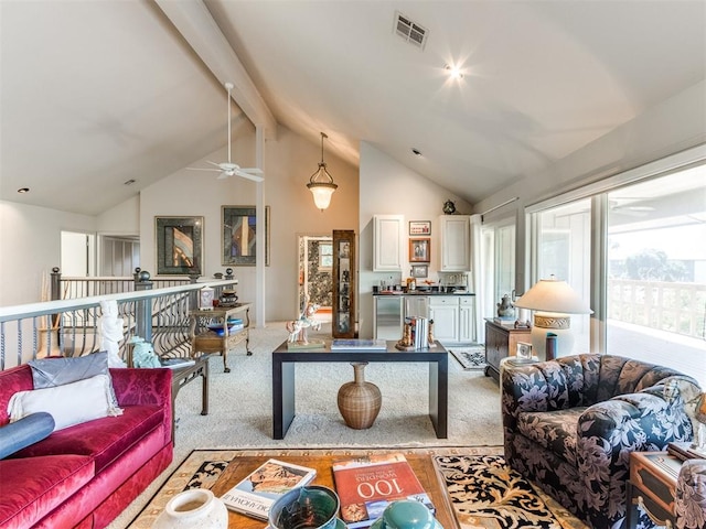 living room with beam ceiling, light colored carpet, high vaulted ceiling, and ceiling fan