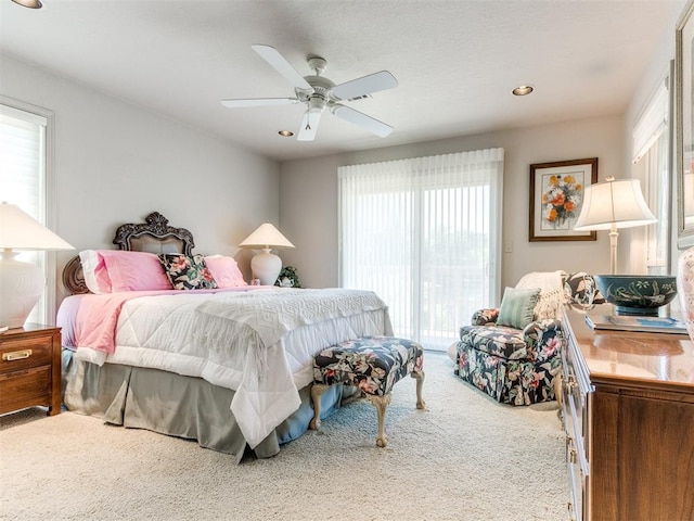 bedroom with carpet, ceiling fan, and multiple windows