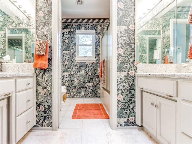 full bathroom with tile patterned floors, vanity, toilet, and enclosed tub / shower combo