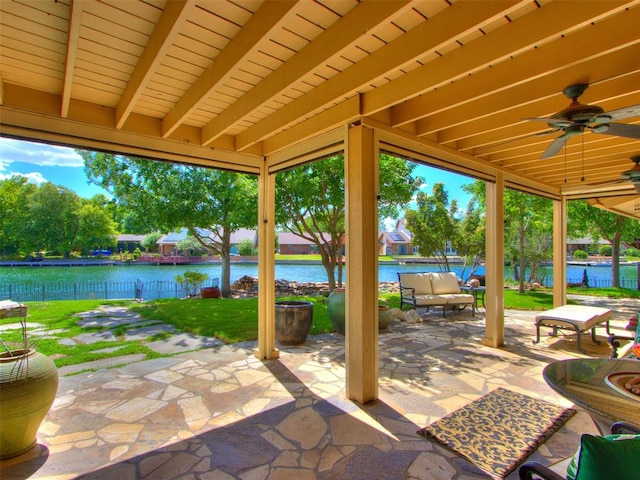 view of patio / terrace with a water view and ceiling fan