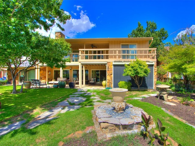 rear view of house with a lawn, an outdoor hangout area, ceiling fan, a balcony, and a patio area