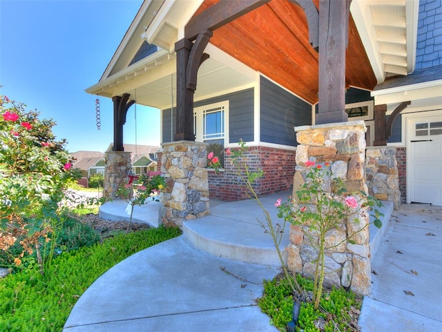 view of exterior entry featuring a porch