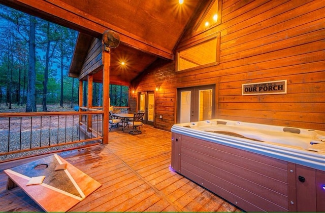 wooden deck featuring a hot tub