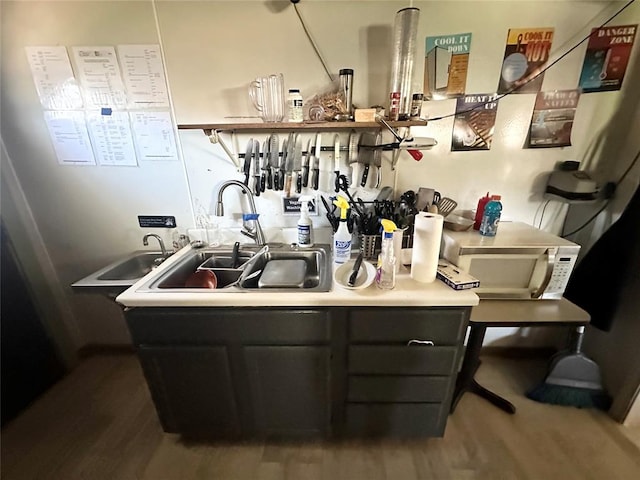 bar featuring sink and wood-type flooring