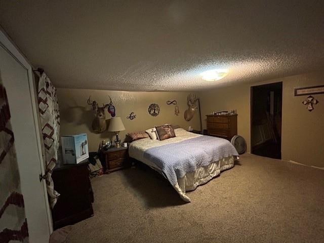 carpeted bedroom featuring a textured ceiling