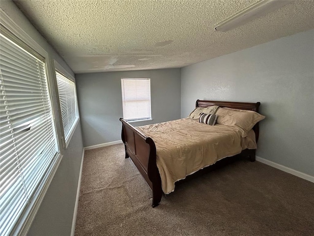 carpeted bedroom featuring a textured ceiling