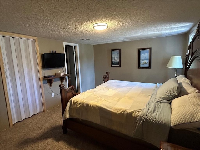 bedroom with carpet and a textured ceiling