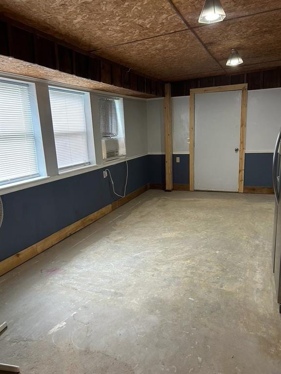 basement featuring stainless steel refrigerator and cooling unit