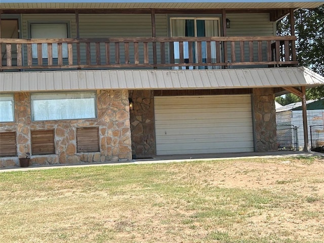 view of front of property with a garage and a balcony