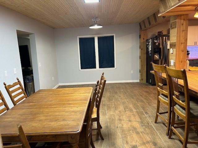 dining area with wood-type flooring and wood ceiling