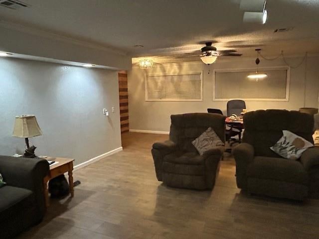 living room with hardwood / wood-style flooring and ceiling fan