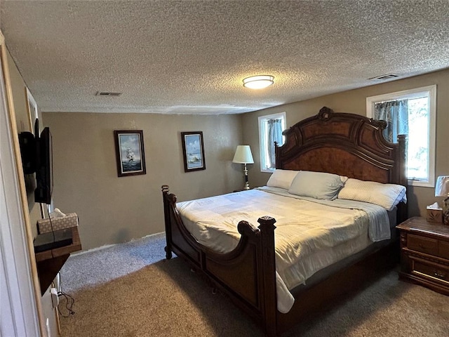 carpeted bedroom featuring a textured ceiling