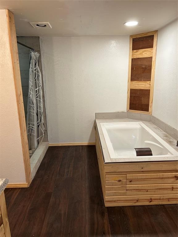 bathroom featuring hardwood / wood-style floors and curtained shower