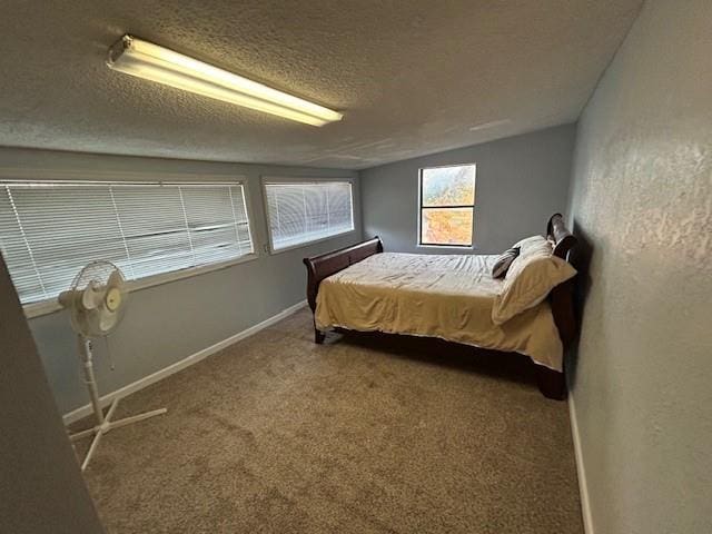 carpeted bedroom featuring a textured ceiling