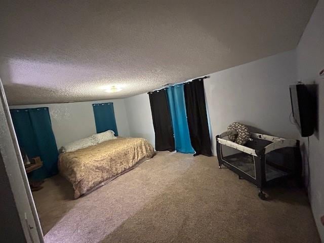 bedroom with carpet floors and a textured ceiling