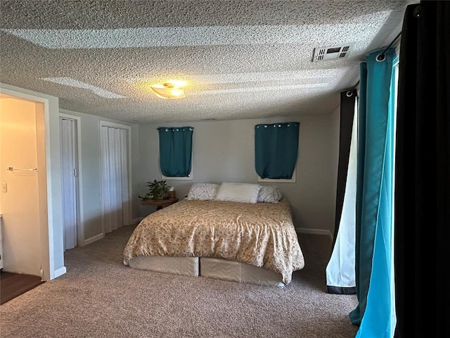 bedroom featuring carpet floors and a textured ceiling