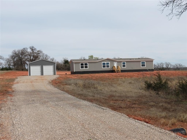 ranch-style house featuring a garage and an outdoor structure