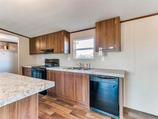 kitchen with hardwood / wood-style flooring, sink, a textured ceiling, and black appliances