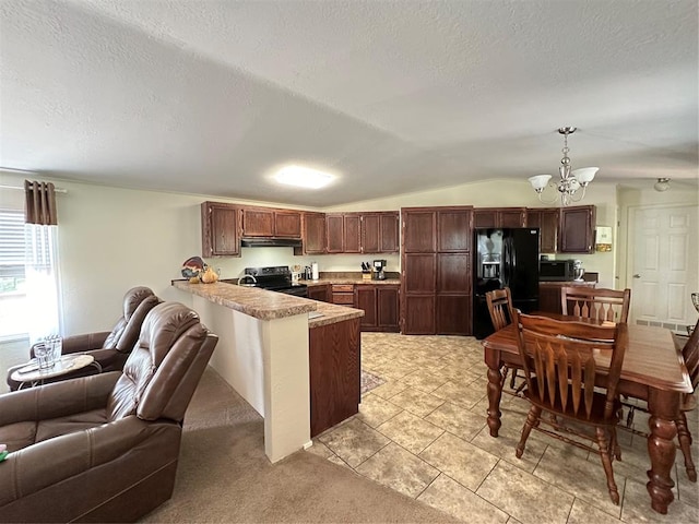 kitchen with hanging light fixtures, an inviting chandelier, kitchen peninsula, lofted ceiling, and appliances with stainless steel finishes