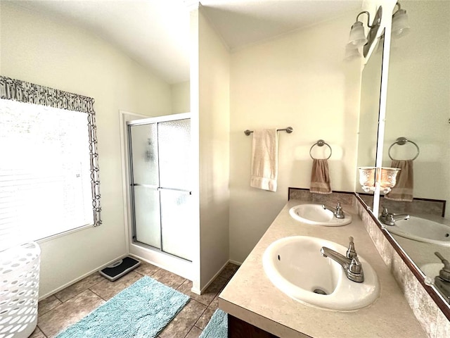 bathroom featuring tile patterned flooring, vanity, vaulted ceiling, and an enclosed shower