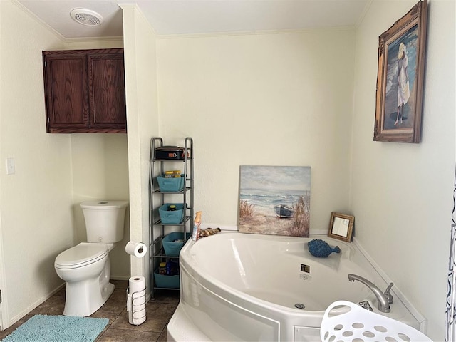 bathroom with tile patterned flooring, toilet, crown molding, and a tub to relax in