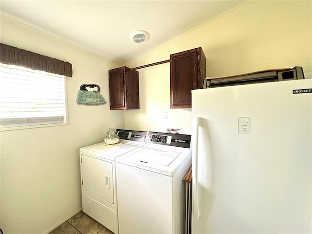 laundry area with washer and dryer, light tile patterned flooring, and cabinets