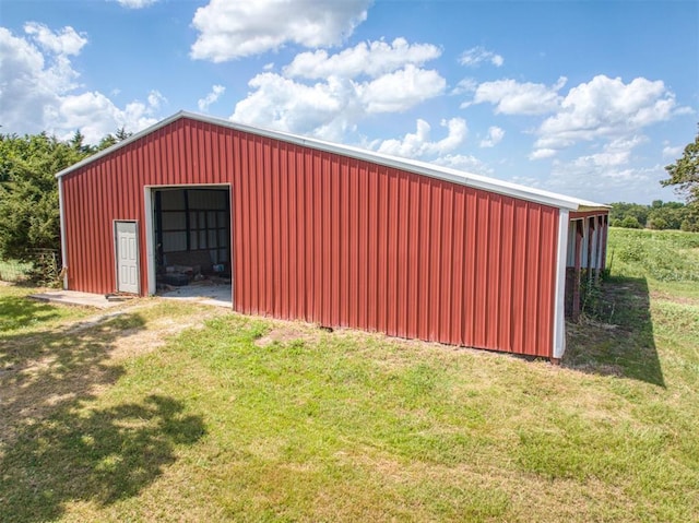 view of outdoor structure featuring a lawn