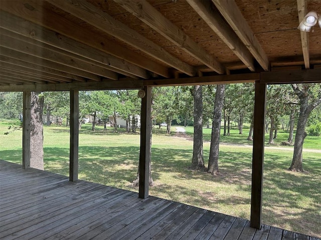 wooden deck featuring a lawn