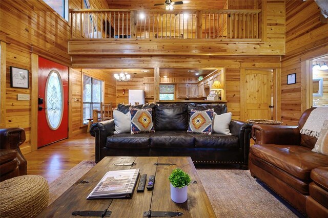 66 Lost Oaks Trl, Broken Bow, OK 74728 - living area featuring wooden walls, a towering ceiling, ceiling fan, and wood finished floors