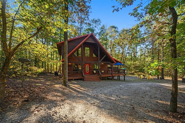 66 Lost Oaks Trl, Broken Bow, OK 74728 - rustic home featuring log veneer siding and a wooden deck