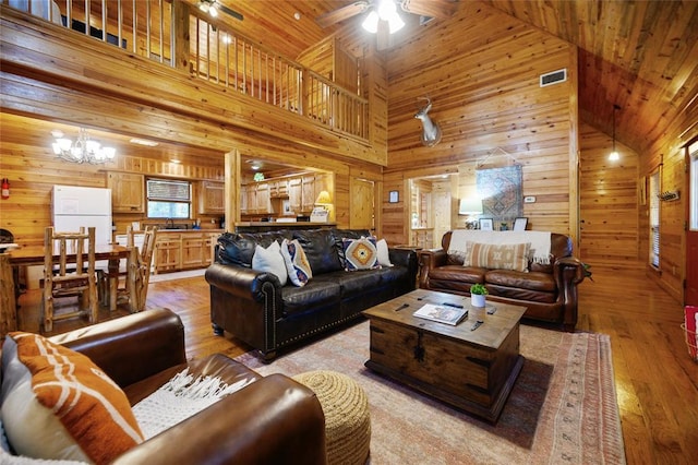 66 Lost Oaks Trl, Broken Bow, OK 74728 - living area featuring wooden walls, high vaulted ceiling, ceiling fan, light wood-type flooring, and wood ceiling