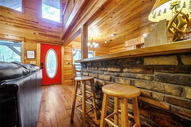 66 Lost Oaks Trl, Broken Bow, OK 74728 - bar area with wood walls, hardwood / wood-style floors, a skylight, a chandelier, and wood ceiling