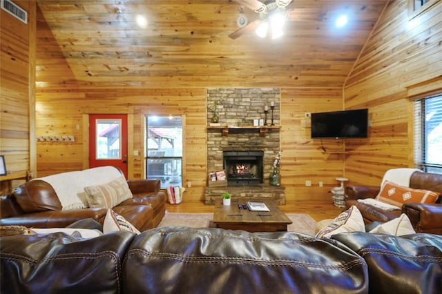 living room with wood ceiling, ceiling fan, wooden walls, high vaulted ceiling, and a fireplace