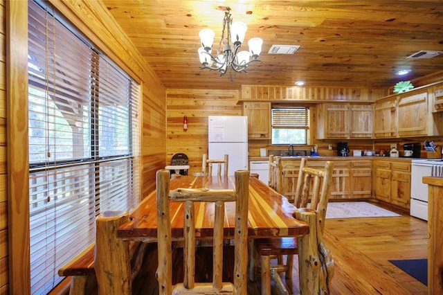 66 Lost Oaks Trl, Broken Bow, OK 74728 - dining room with a chandelier, wood ceiling, wood walls, and light wood-style floors